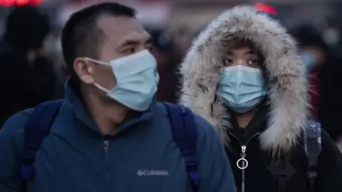Getty Images People wearing masks