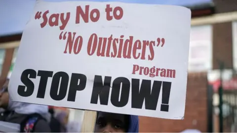 Getty Images/Christopher Furlong Protester holding banner