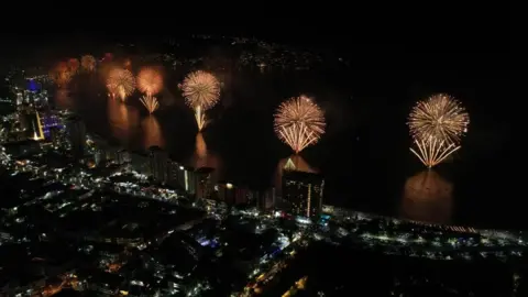 EPA-EFE/REX/Shutterstock Fireworks illuminate the night sky over Balneario resort city during New Year's celebrations in Acapulco, Mexico