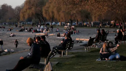 Reuters People gather at sunset, during the coronavirus disease (COVID-19) outbreak, at Golden Gardens Park in Seattle, Washington, U.S. March 21, 2020