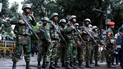 Getty Images Bangladeshi soldiers stand guard in the capital Dhaka