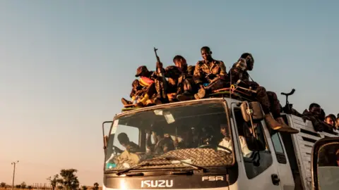 AFP Ethiopian soldiers on the back of a lorry on a road near the city of Humera, Ethiopia - 21 November 2020