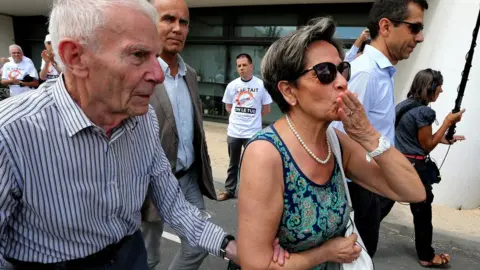 Getty Images Pierre (left) and Viviane Lambert, the parents of Vincent Lambert, campaigning for their son to be kept alive, 23 July 2015