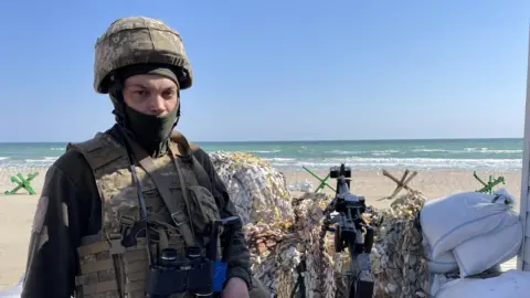 BBC News  A Ukrainian soldier mans an anti-aircraft gun in the historic city of Odesa.