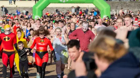 Getty Images The swims across Wales, including at Barry Island, raise thousands for charities