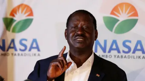 Reuters Raila Odinga at news conference, behind him the logo of his movement the National Super Alliance - 9 August