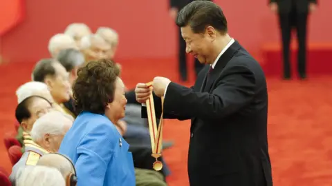CNS Anna Chennault receiving a medal from Xi Jinping