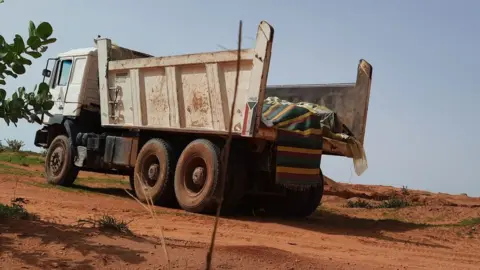 truck with covered up bodies in it