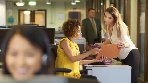 Office workers discuss something