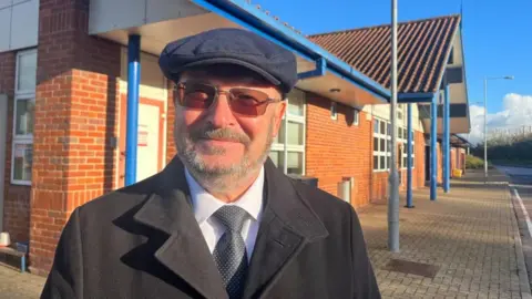 ANDREW TURNER/BBC Councillor Graham Plant outside Postwick Park and Ride customer building.