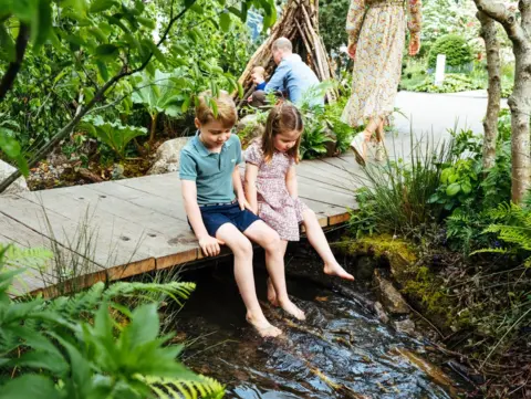 Matt Porteous Prince George and Princess Charlotte dangle their legs over the stream