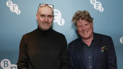 Millie Turner/BFI Neal Purvis (left), Robert Wade (right)