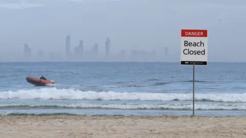 Getty Images Lifeguards patrol waters off a closed Gold Coast beach after a fatal shark attack