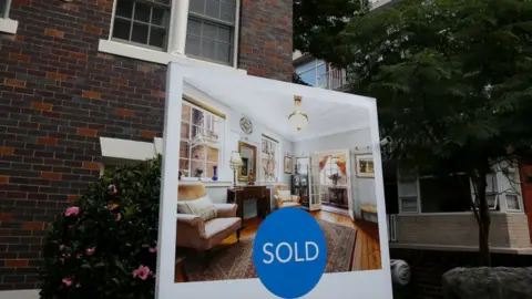 Getty Images A 'sold' sign outside an apartment block in Sydney Australia.