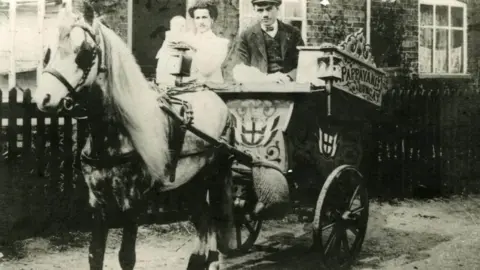 Parravanis Black and white photo of couple on ice cream carriage