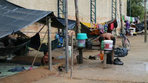 Members of the Warao indigenous community have built shelters of tarpaulin