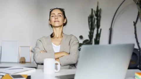 Getty Images Woman takes a break at her laptop