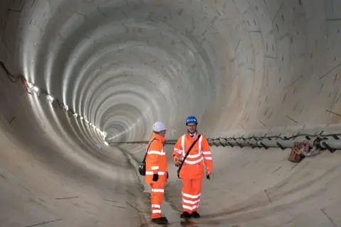 PA Media Transport Secretary Mark Harper (right) and HS2 CEO Mark Thurston view a one-mile section of the first completed tunnel under ancient woodland near Southam, Stratford-on-Avon, Warwickshire, for the HS2 project. Picture date: Thursday December 1, 2022.