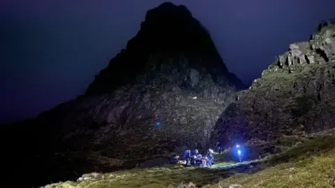 Cockermouth Mountain Rescue Team Rescuers beside mountain