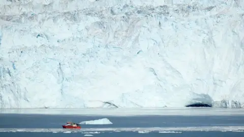 Getty Images A boat by the coast of Greenland