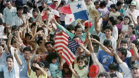 AFP A large number of Panamanians opposed to General Manuel Antonio Noriega wave American and Panamanians flags outside a military post 22 December 1989.