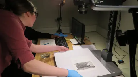 National Trust/Josh Ward Digitising a page from one of Mercie Lack’s photograph albums