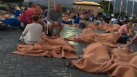 Keith Prested Holidaymakers sleep outside under blankets
