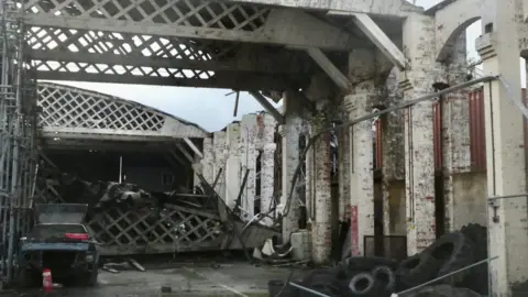 Photo of partially collapsed aircraft hanger