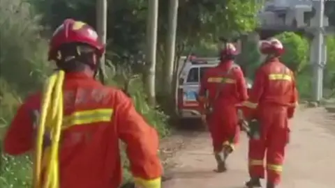 Alamy Rescuers at the site