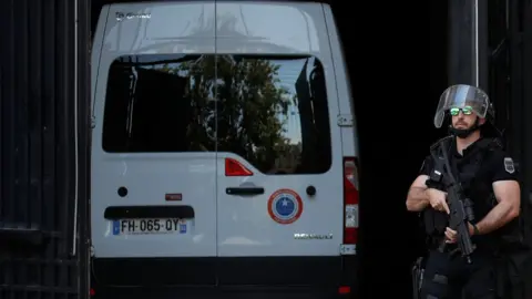 Rex Features A police convoy believed to be carrying Rwandan genocide fugitive Felicien Kabuga arrives at the Paris courthouse