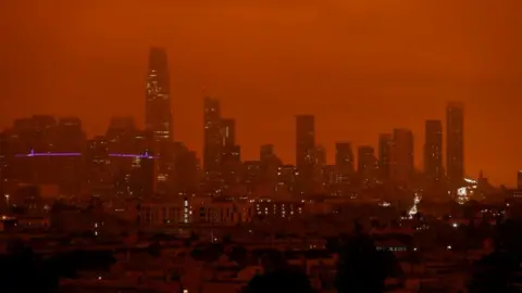 Reuters Downtown San Francisco is seen from Dolores Park under an orange sky