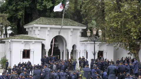 AFP Algerian police are seen in front of president's headquarters during their strike - 15 October 2014
