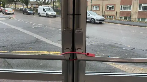 Lydia Caunce Fire exit being closed shut with cable ties