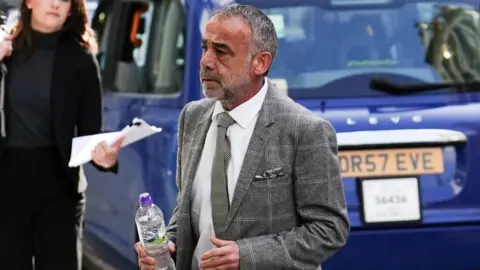 PA Media Coronation Street actor Michael Le Vell arrives at the High Court in London on the first day of the trial