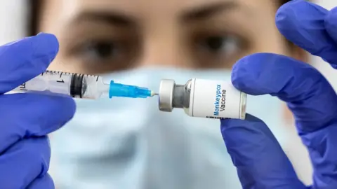 Reuters Doctor holding vaccine