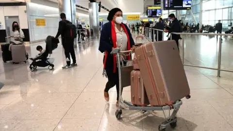 EPA Travellers arriving at Heathrow airport