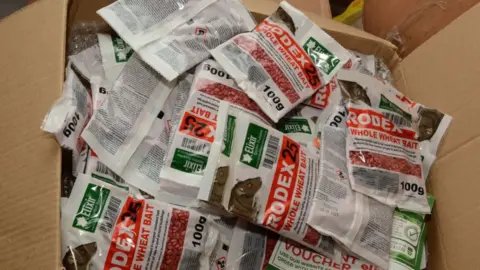 SWROCU A box full of packets of rat poison