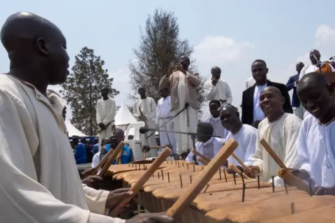 Badru Katumba/AFP Men playing music instruments, 31 July 2023
