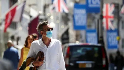 Reuters Man in mask in UK