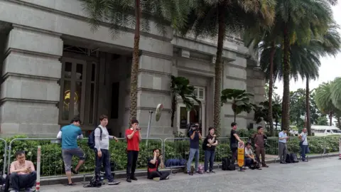 AFP/Getty Reporters outside Kim's hotel