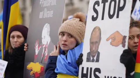 PA Media Ukrainians hold a protest against the Russian invasion of Ukraine outside Downing Street