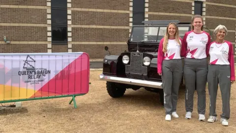 British Motor Museum Baton bearers Abagail Vincent, Letitia Cowley and Jenny Waggott at the British Motor Museum