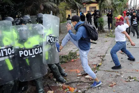 Carlos Ortega/EPA Demonstrators clash with the police during a protest
