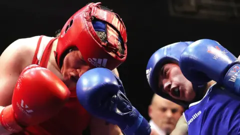 Amy Broadhurst takes a punch from Grainne Walsh in the final