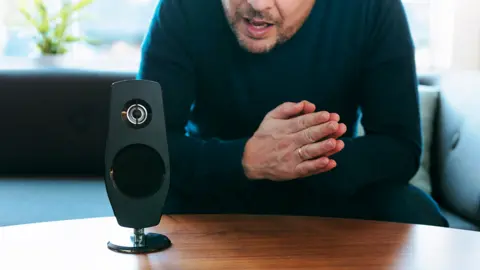 Getty Images Man talking to a smart home device