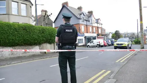 Pacemaker Outside the house after the murder with police officer and cordon around the street