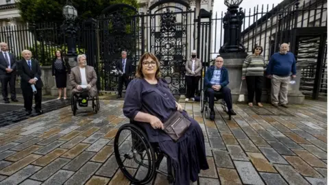 Liam McBurney/PA Jennifer McNern (centre) outside Belfast High Court On Monday