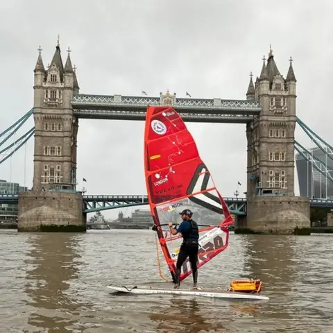 Handout Mr Tinga windsurfing in front of Tower Bridge.