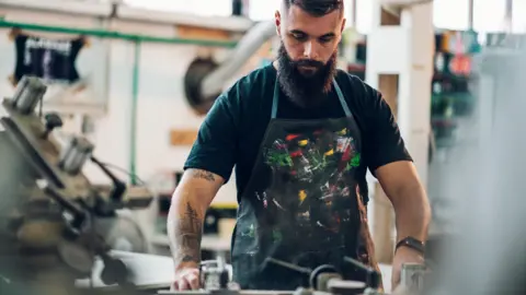 Getty Images Man in a printing machine workshop