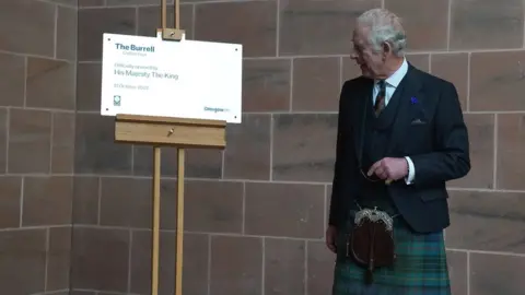 PA Media A plaque marking the royal visit